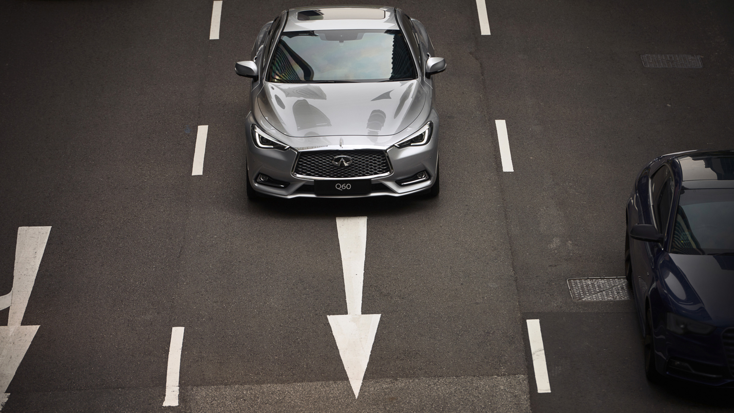 2022 INFINITI Q60 silver car driving in a lane.